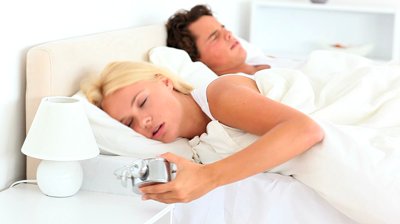 stock-footage-couple-not-wanting-to-wake-up-in-the-bedroom
